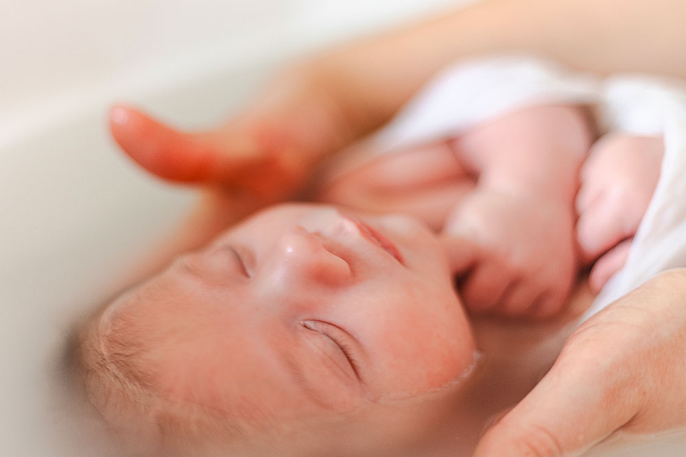 main autour bébé bain enveloppé lisa mazeau photographe professionnelle gironde