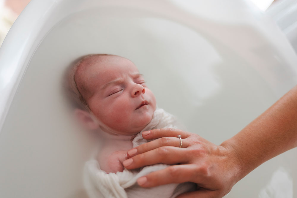 bébé concentré dans un bain enveloppé lisa mazeau photographe professionnelle gironde